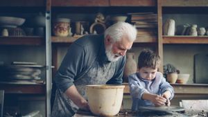 Elderly-man-guides-young-boy